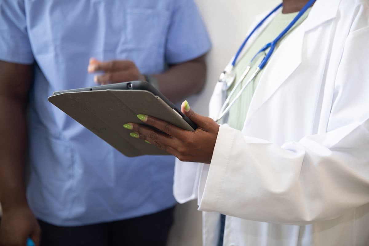 Healthcare professional using a tablet for care coordination