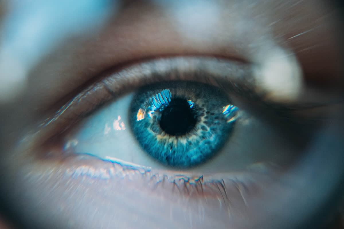 Close up of a human eye reflecting digital code