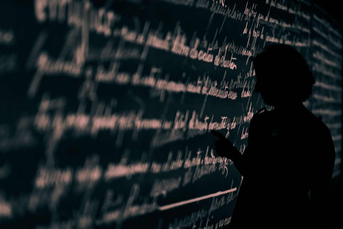 Close up of a person thinking strategically with data visualizations in background