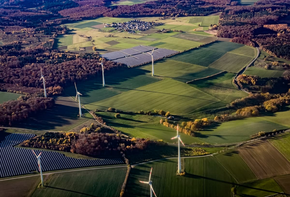 Renewable energy farm with wind turbines and solar panels