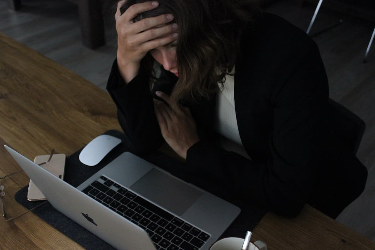 Overwhelmed office worker with multiple screens