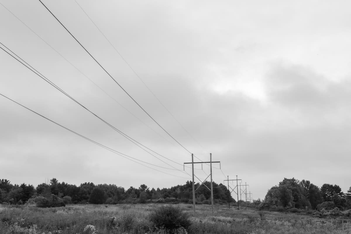 High voltage power lines crossing a rural landscape