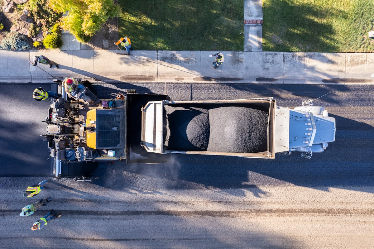 Aerial view of a modern road being paved with recycled materials