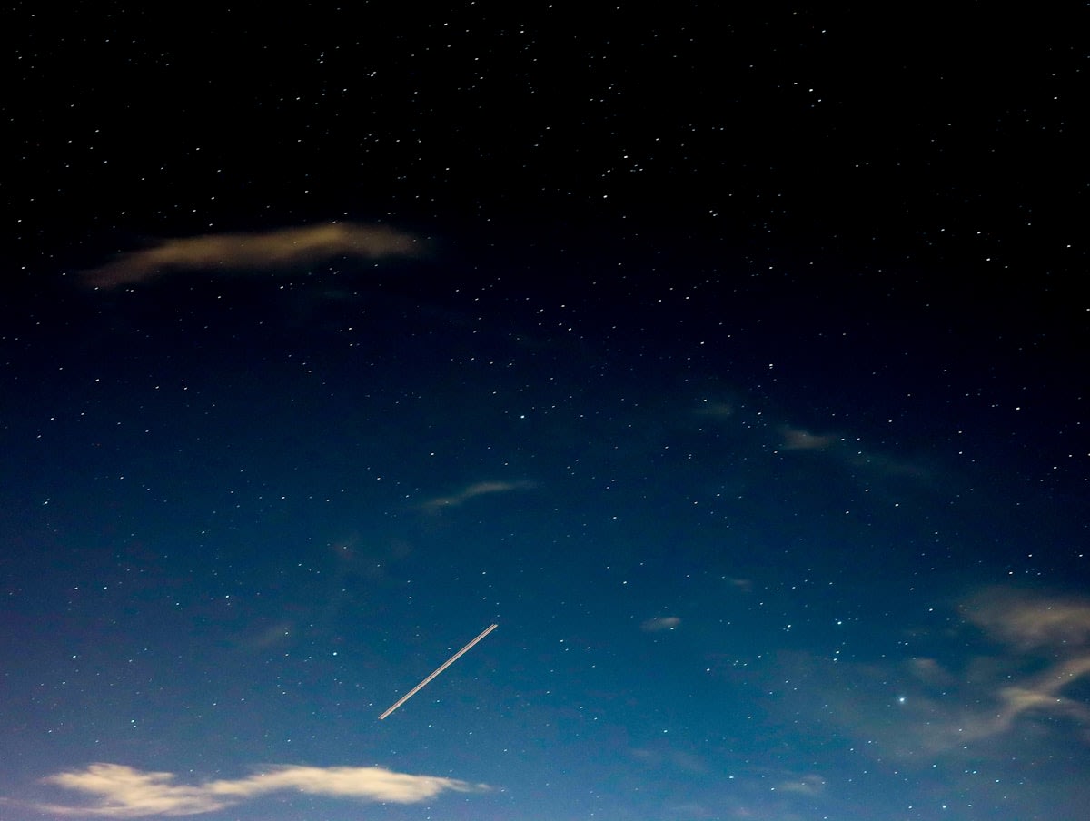 Night sky with satellite streaks