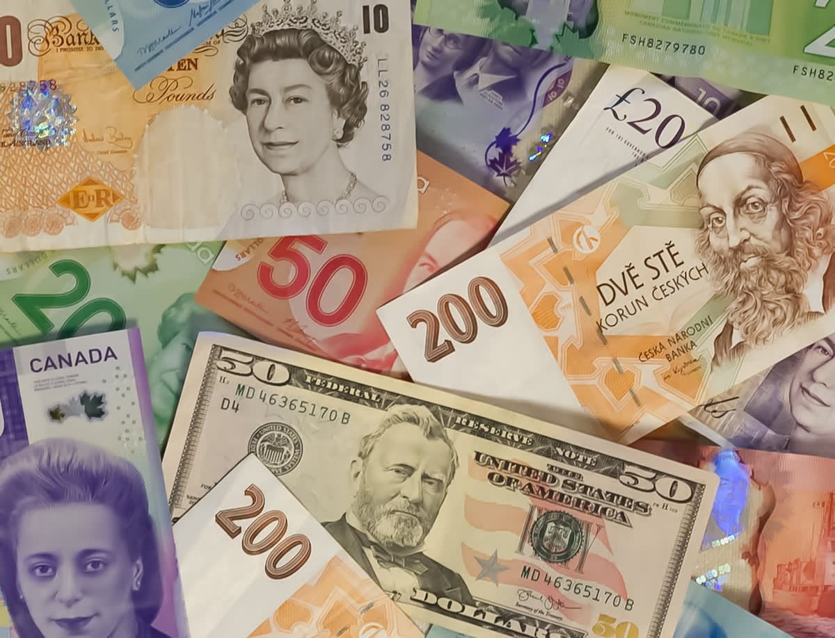 US dollar bills and global currency symbols