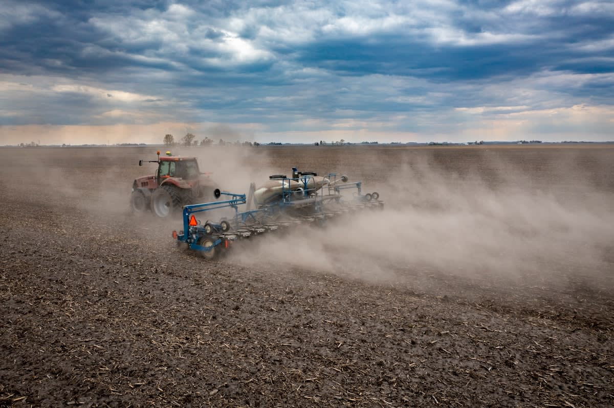 Autonomous tractor in dusty field