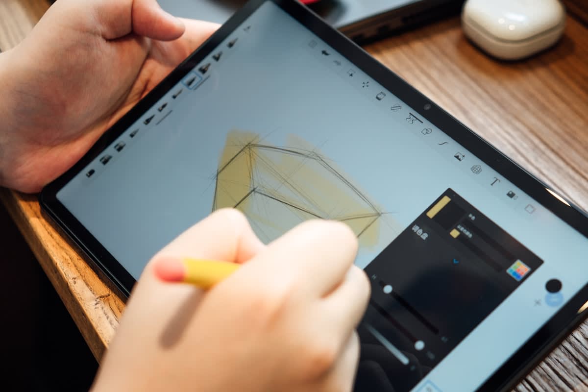 Close up of human hand sketching on a digital tablet