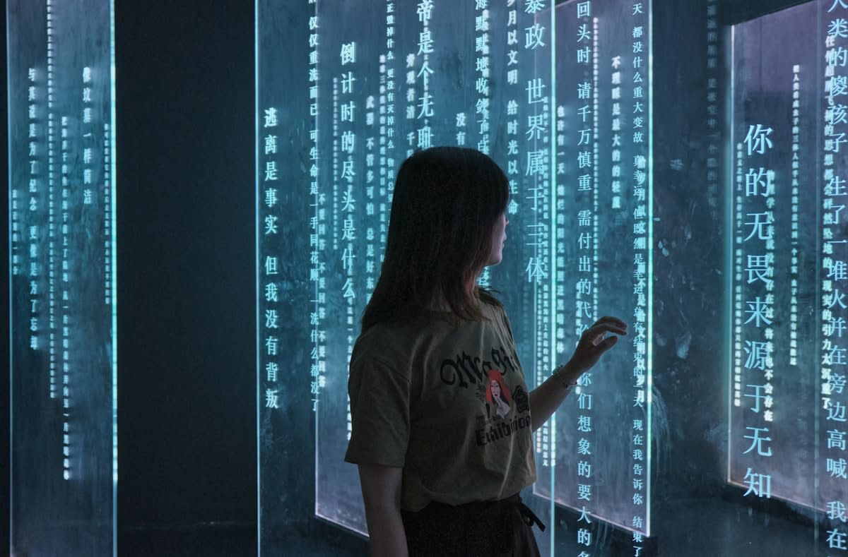 A person looking at multiple digital screens showing complex data