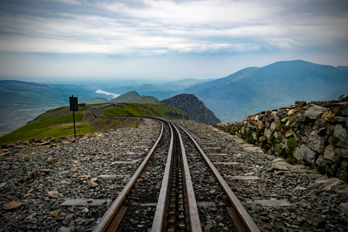 Train tracks winding through a mountain landscape