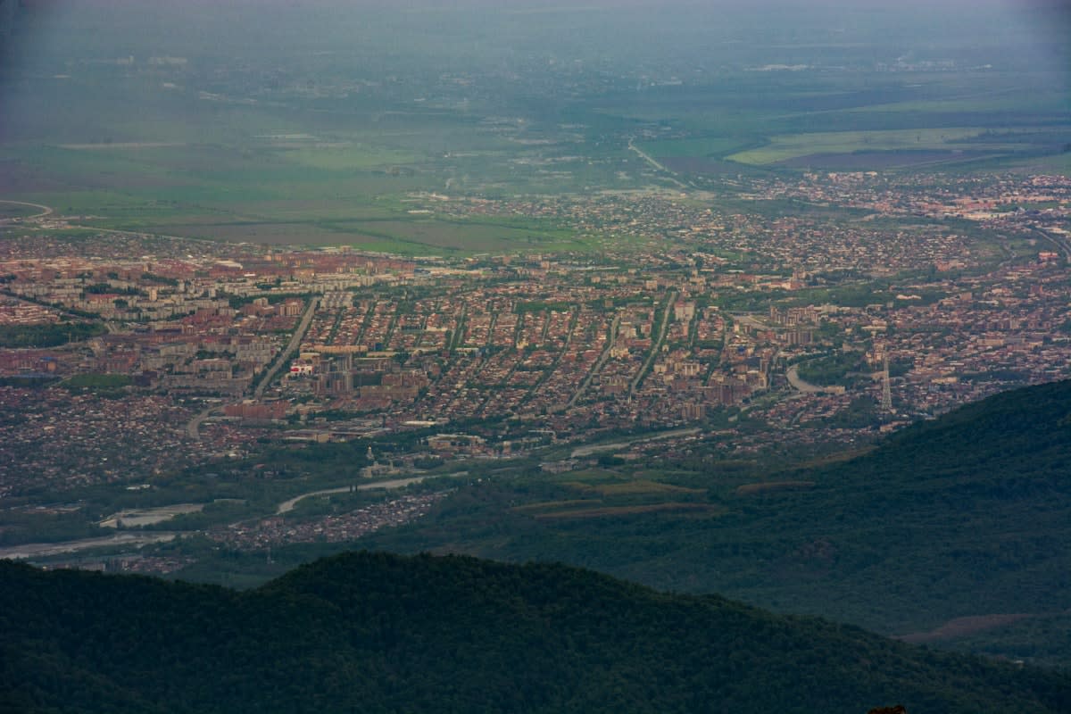 Aerial view of a massive soccer stadium in a high altitude city