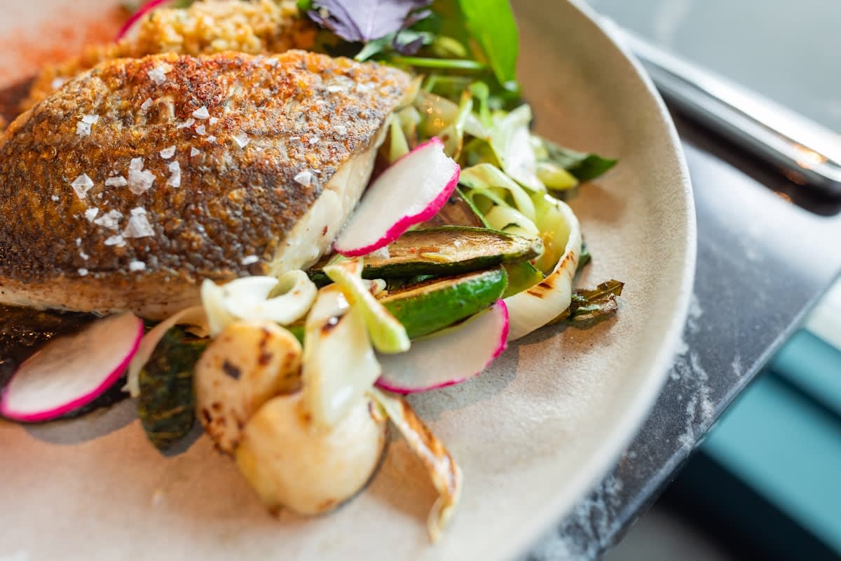 fresh oily fish and vegetables on a plate