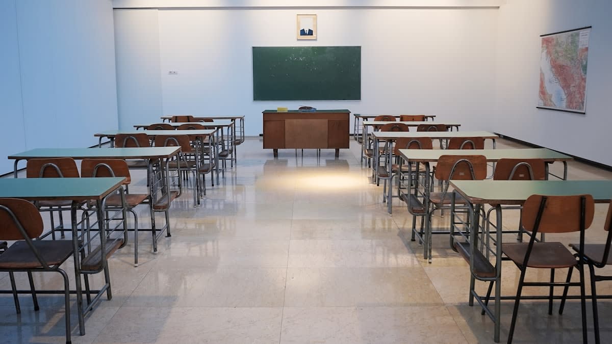 Empty classroom with desks and a chalkboard