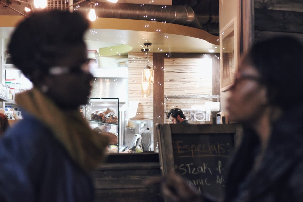 Group of diverse people talking in a city cafe