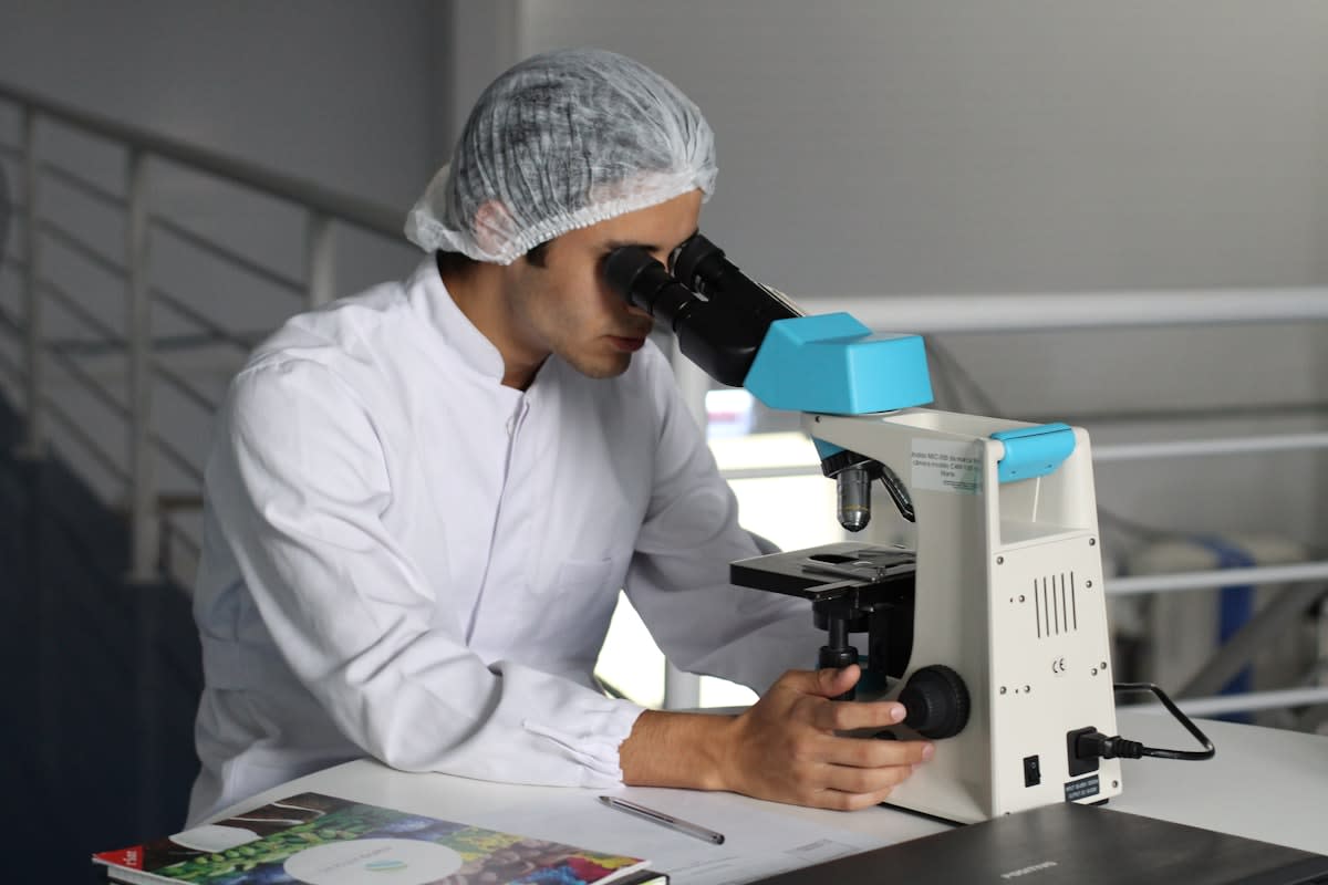 Laboratory researcher with microscope