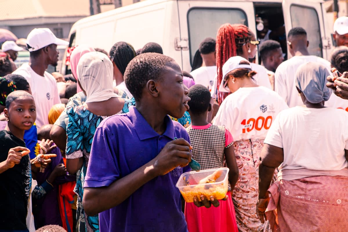 High-angle shot of a busy market in Lagos with people using smartphones