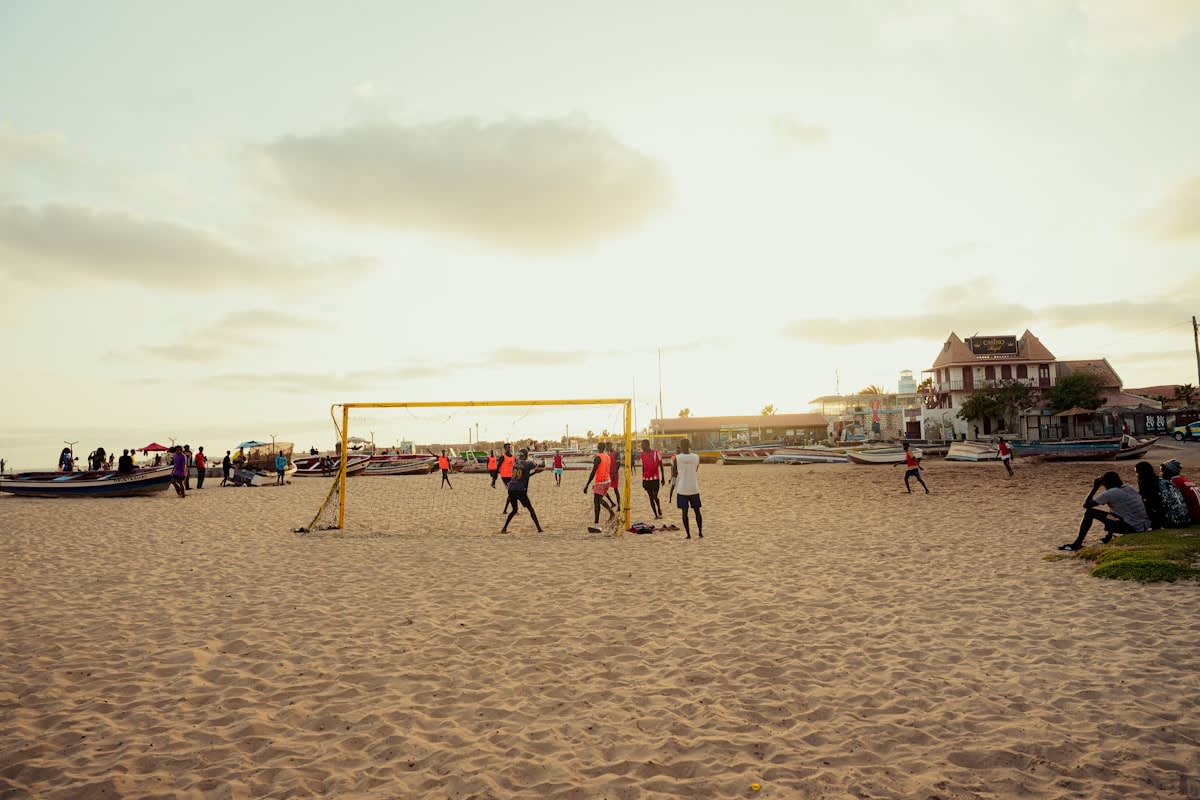 Youth soccer players training on a dusty field in West Africa