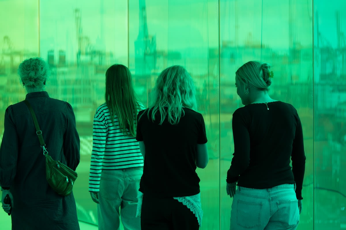 People interacting with digital screens in a modern city
