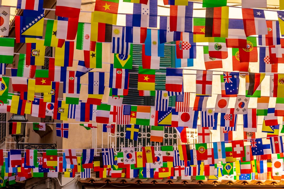 wide shot of a global diplomatic summit with many flags