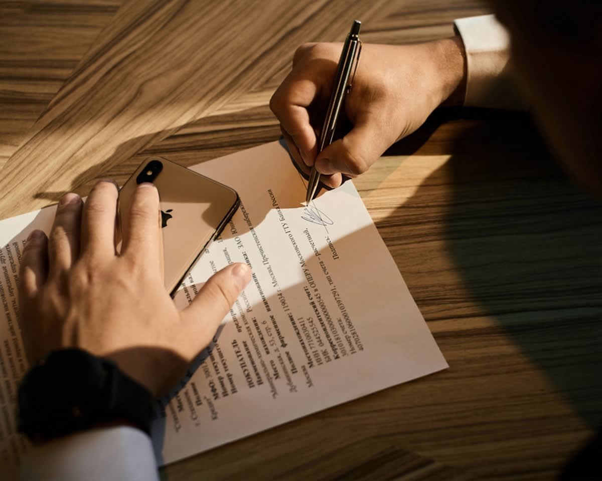Close up of a legal contract and a digital screen