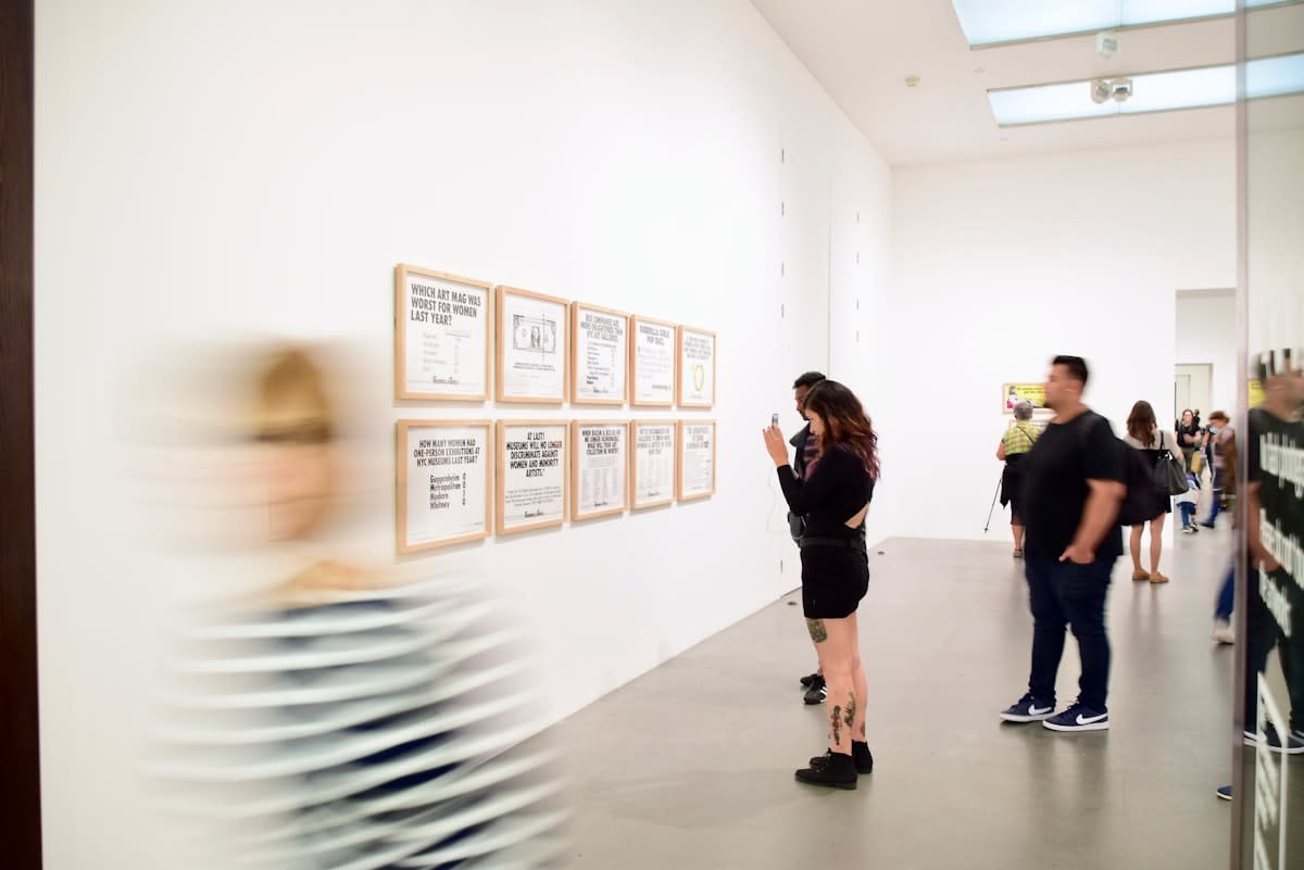 Modern art gallery with white walls and minimalist paintings