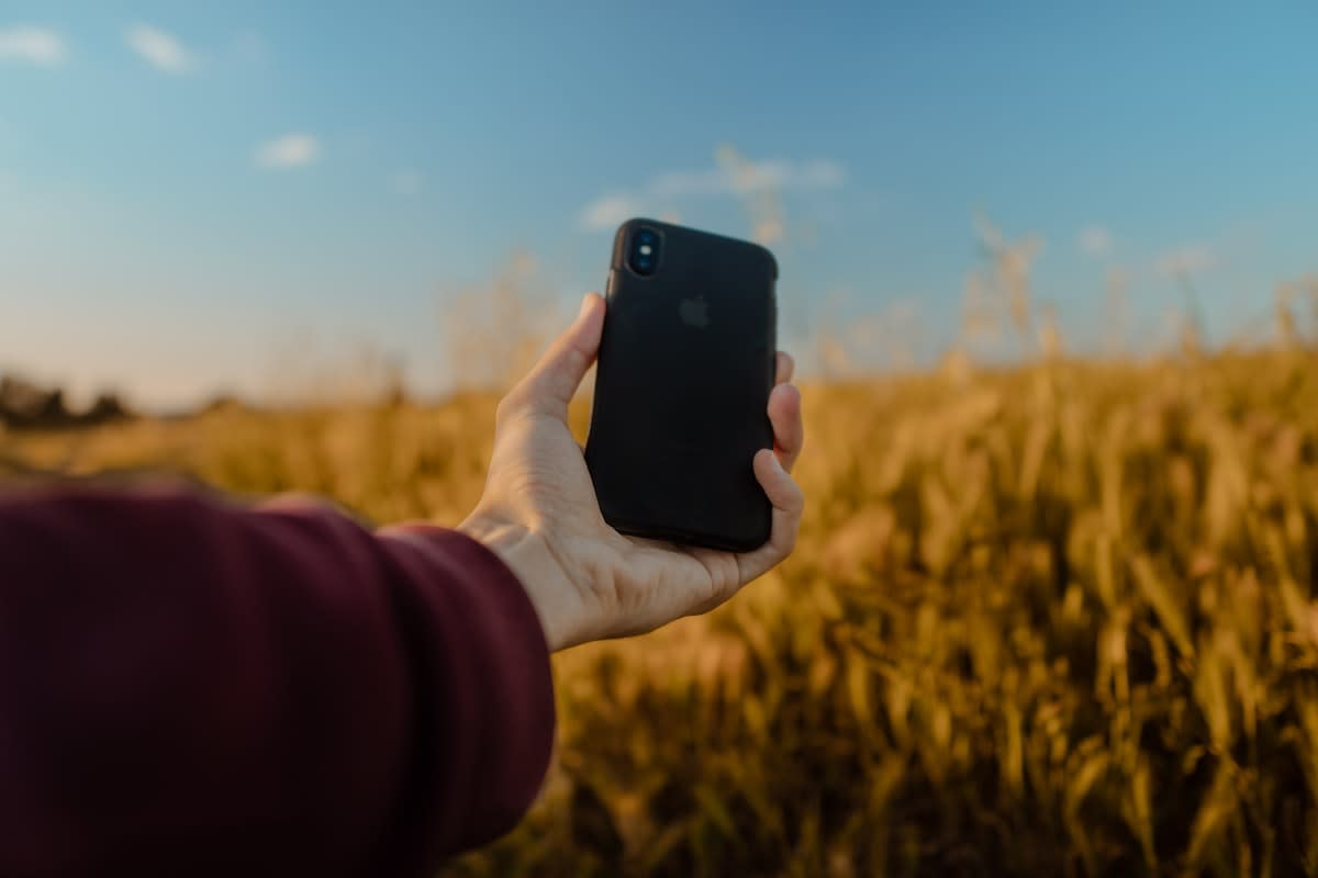 Close up of a mobile phone in a field