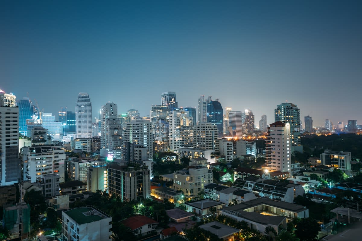 Bangkok night skyline with neon lights and traffic