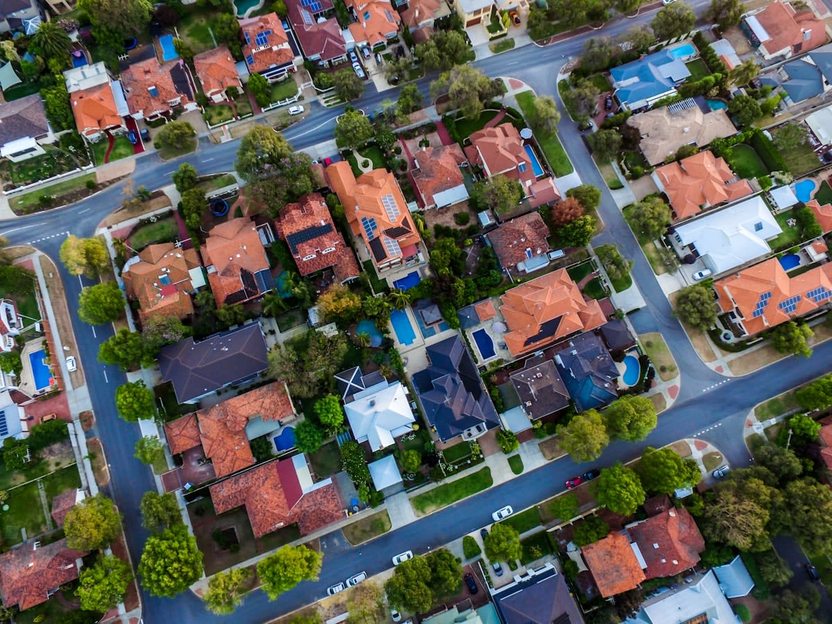 Aerial view of modern Australian urban sprawl with contrasting luxury high-rises and dense suburbs