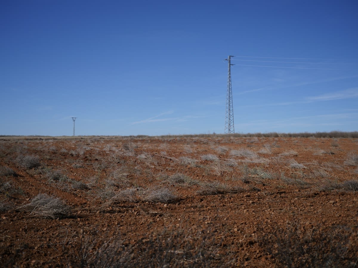 Electrical pylons crossing a dry landscape