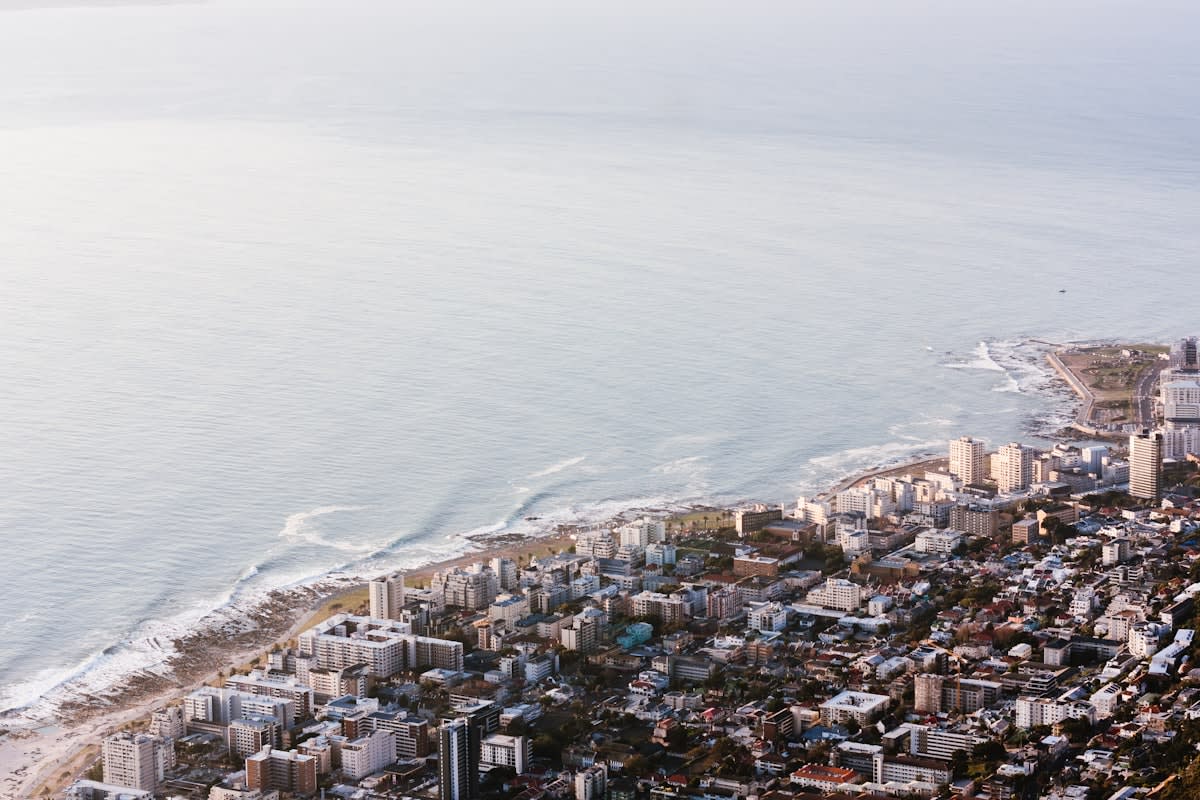 Aerial view of a dense coastal city facing rising sea levels