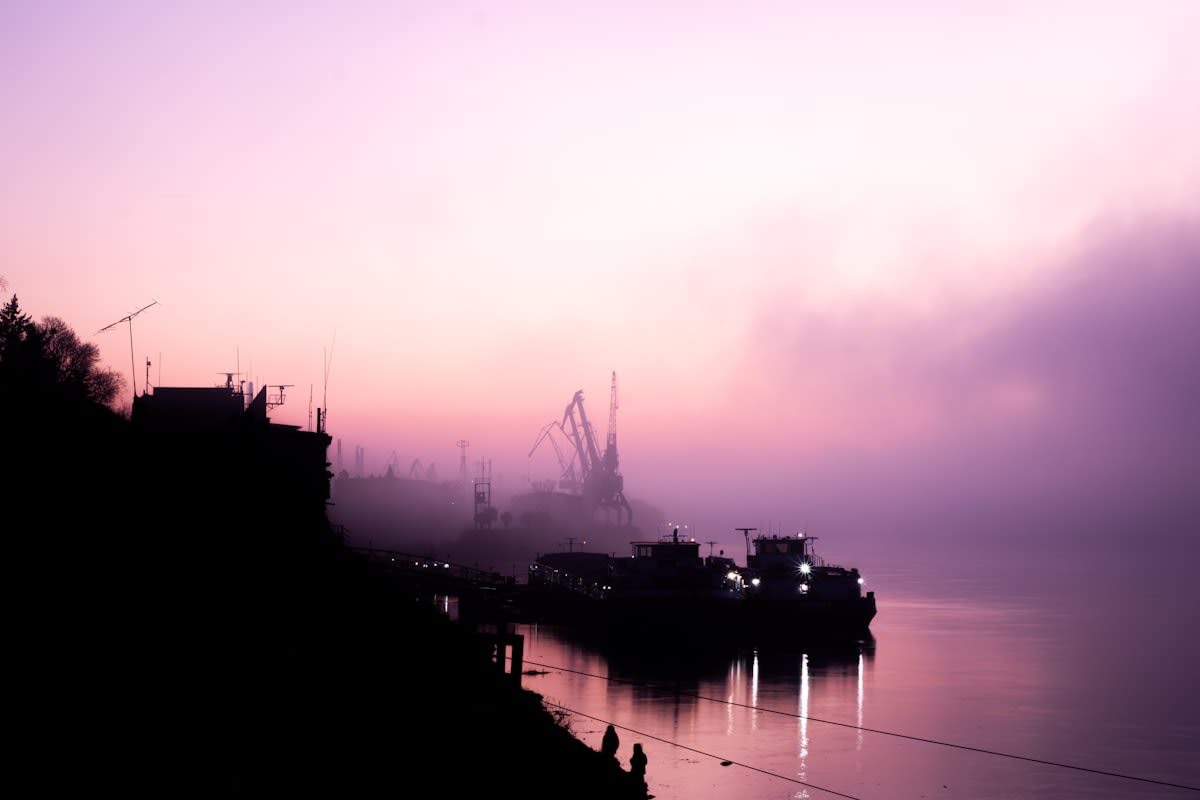 Cargo ships in a foggy harbor