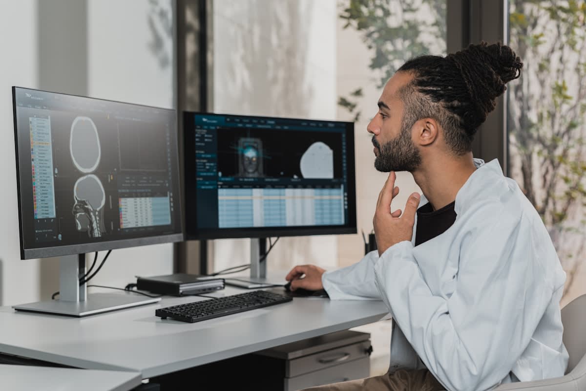 Professional sports analyst using multiple monitors with data
