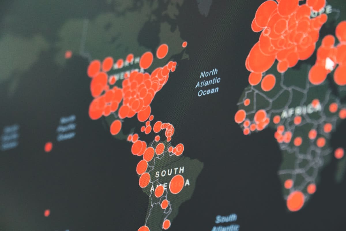 Modern workspace with multiple screens and global maps