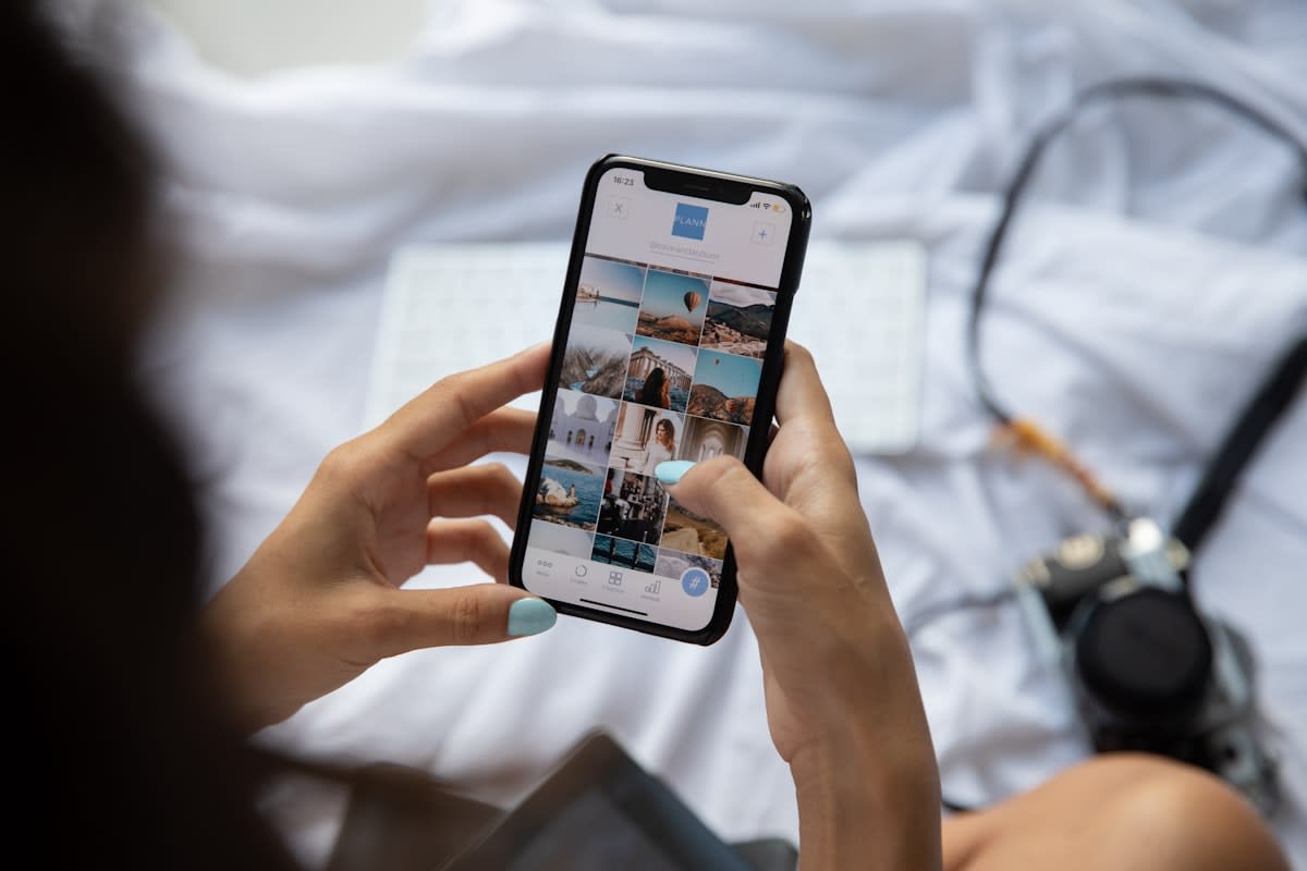 Person scrolling through a vibrant social media shopping feed on a smartphone