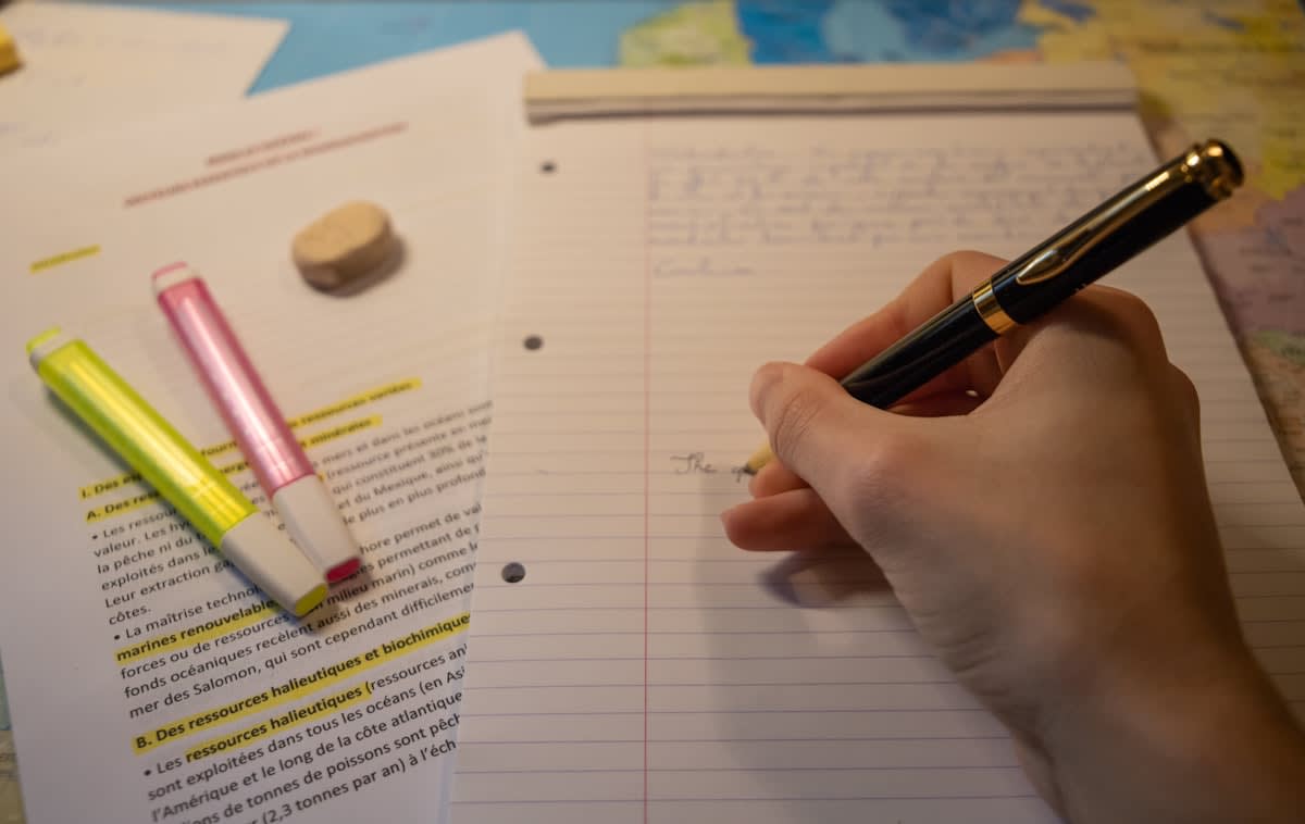 Person analyzing a complex handwritten map and notes