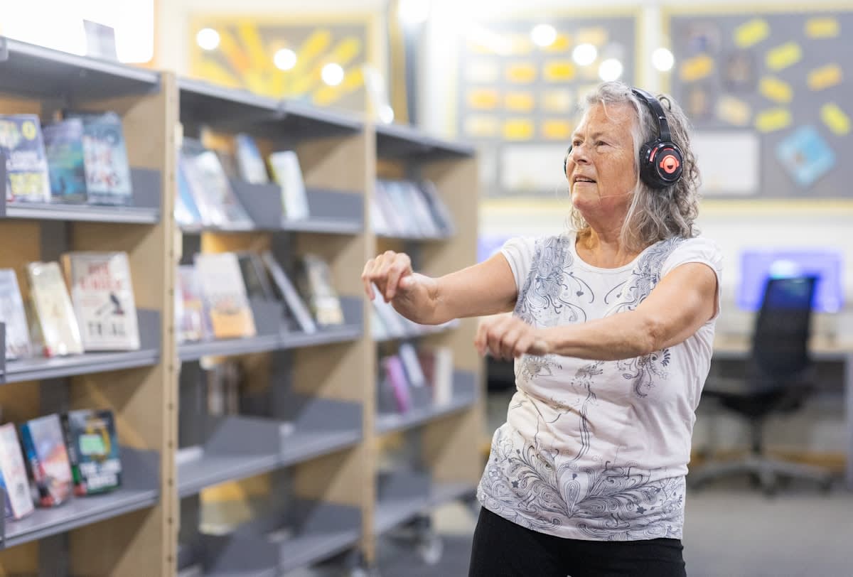 A healthy older adult exercising and reading