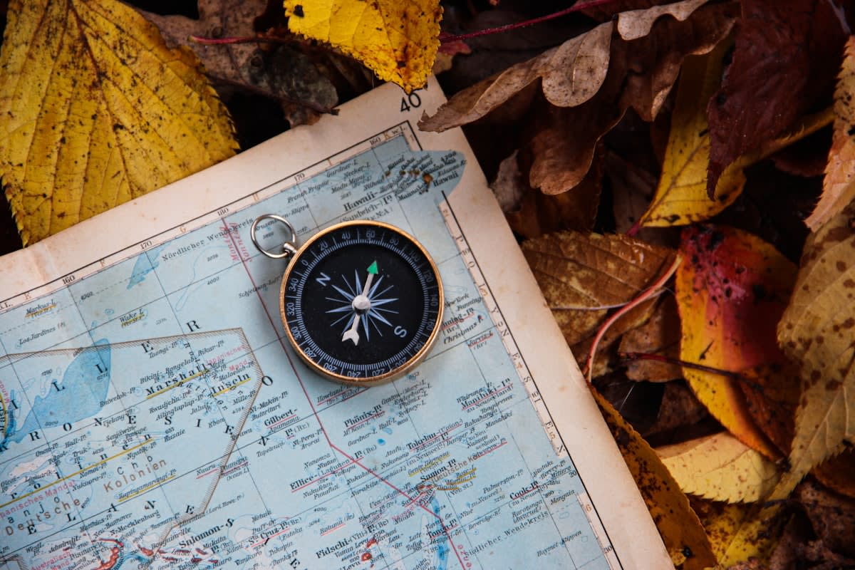 Vintage topographic map and compass on a wooden table