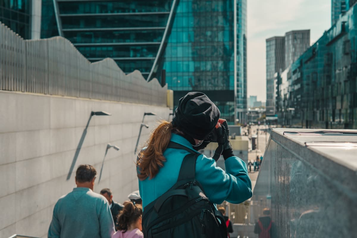 Person engaged in complex urban sketching in a busy city