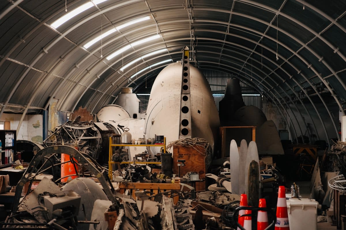 Aircraft hangar with engineers working on a fuselage