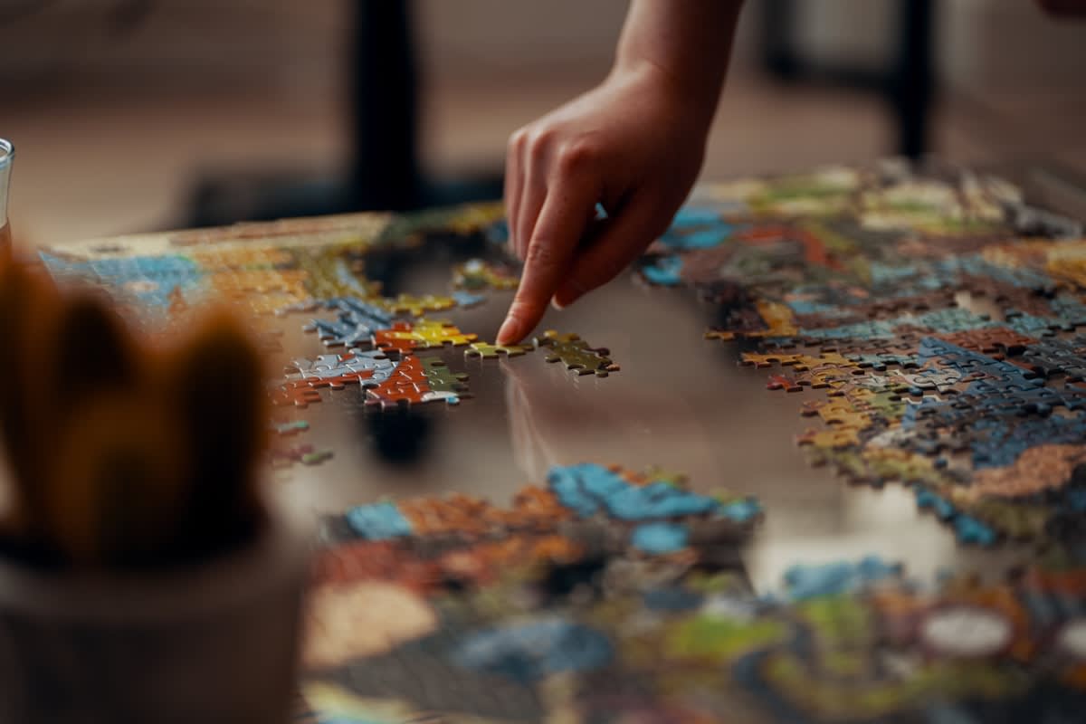 A complex 1000 piece jigsaw puzzle on a wooden table