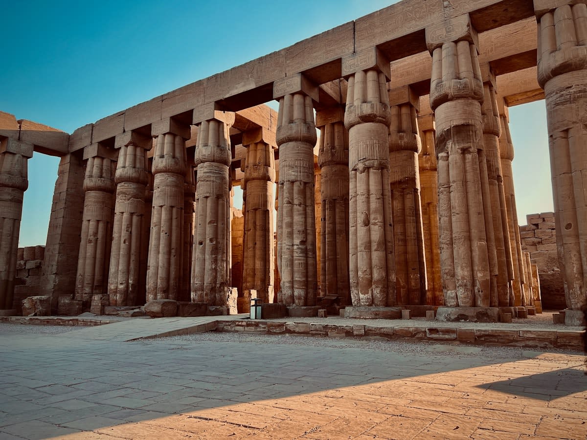 Ancient Egyptian temple ruins at sunset
