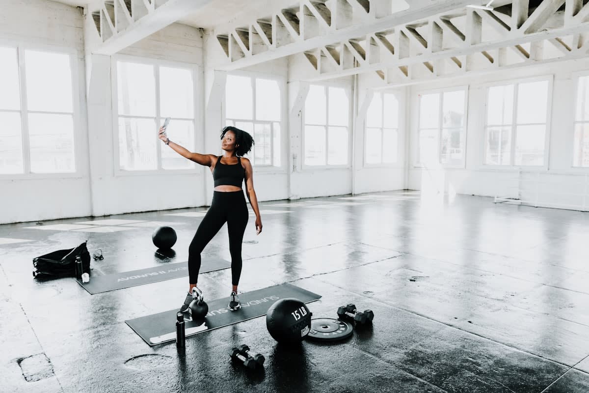 Person meditating or stretching in a modern gym