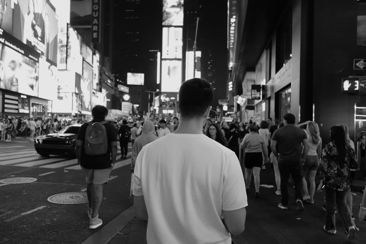 A person meditating in a busy urban environment