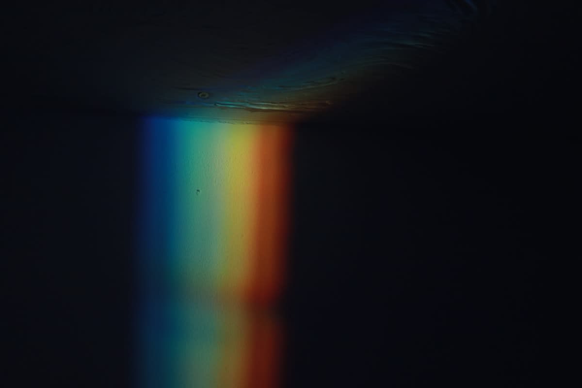 A prism breaking a single beam of white light into a spectrum of colors