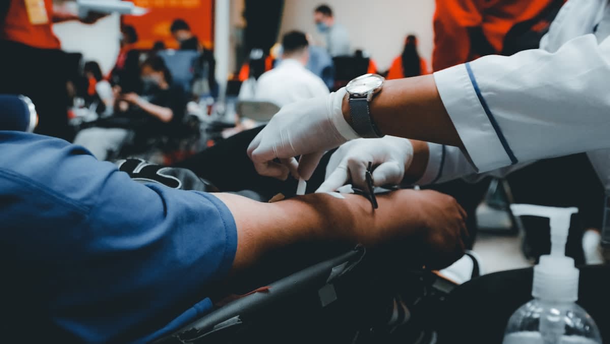 Close up of a medical professional drawing blood from a patient