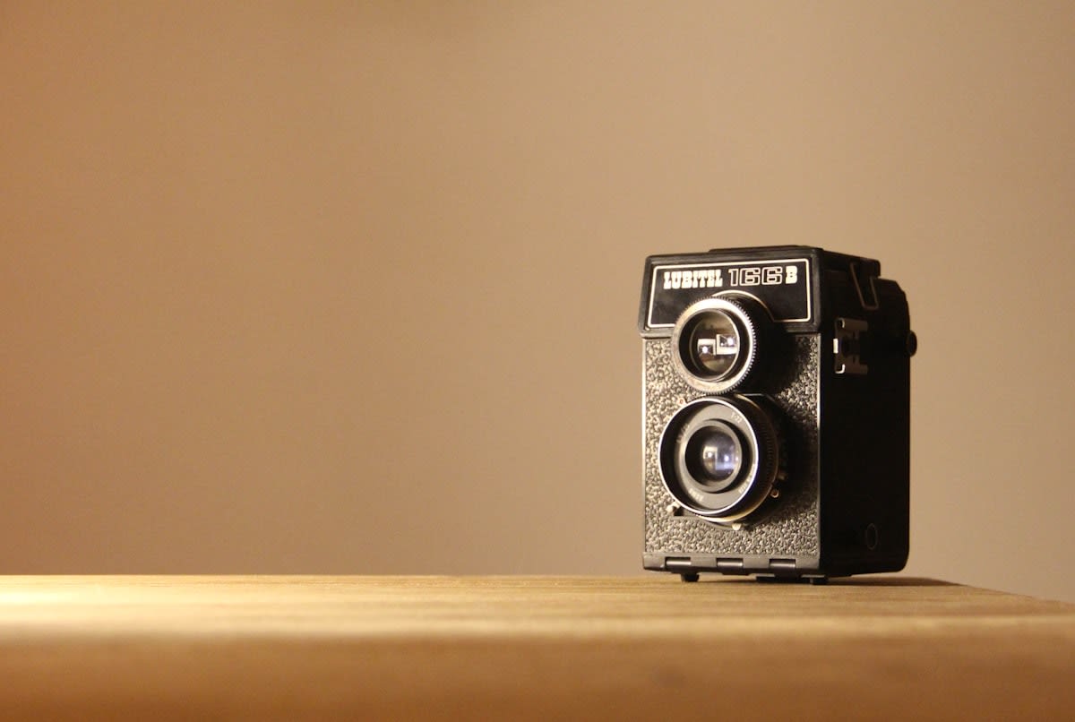 vintage 35mm film camera on a wooden table