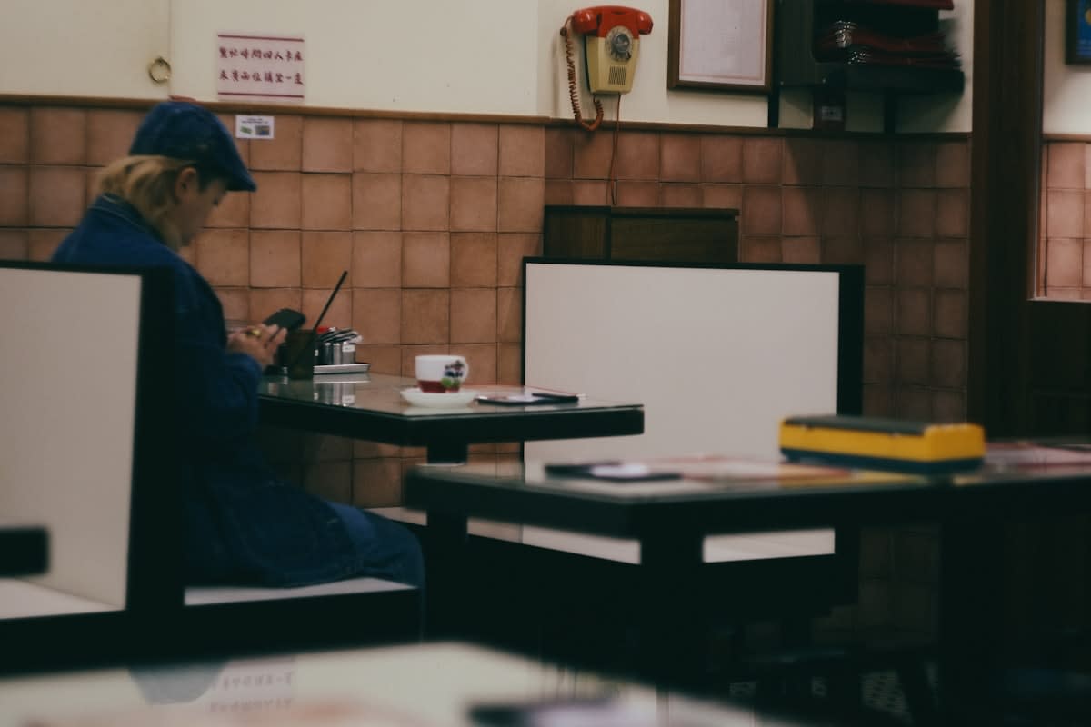 Person working on a laptop in a quiet cafe