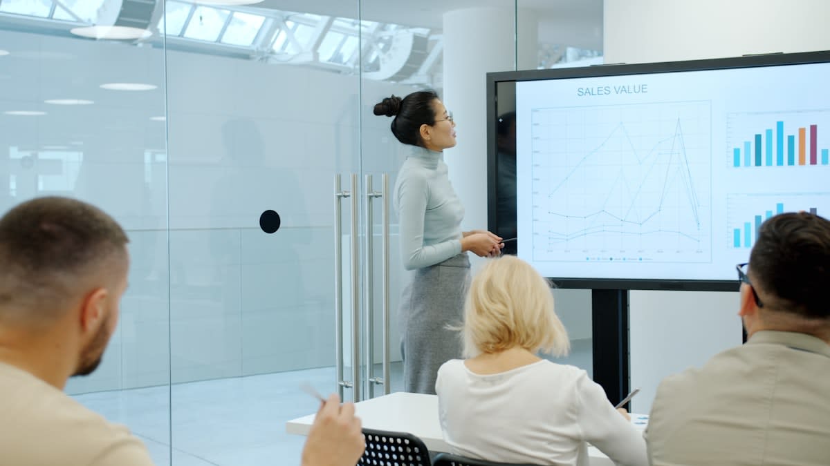 Modern corporate office with digital screens showing data