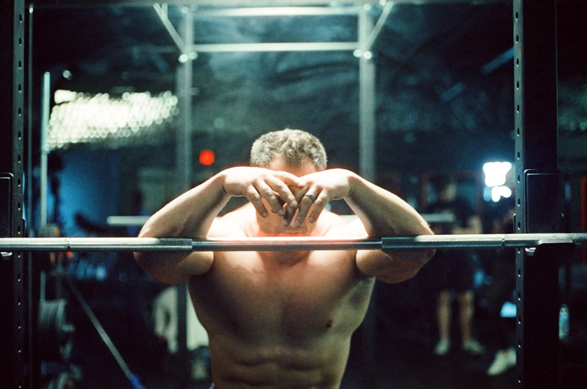 Close up of an athlete looking exhausted in a gym