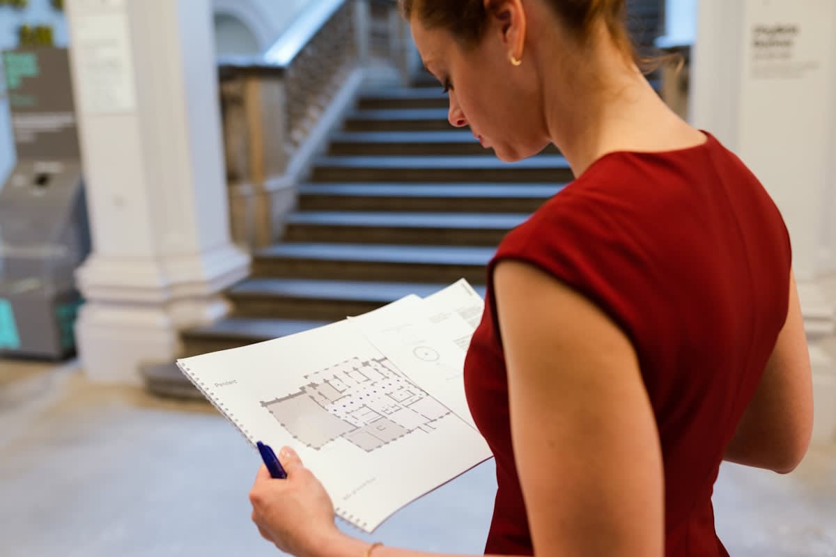 A person looking at a complex architectural blueprint