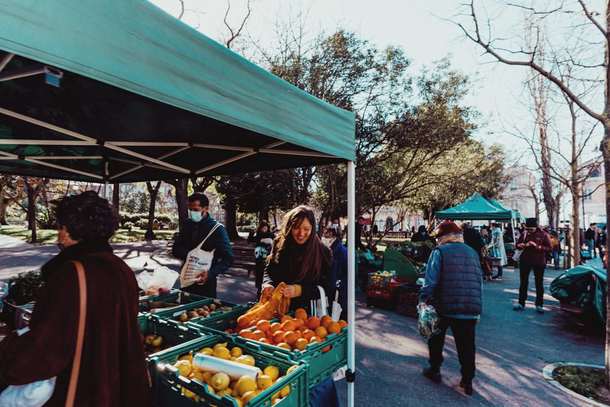 Local farmers market with people exchanging goods